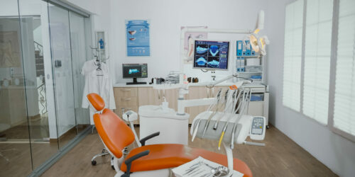 Empty stomatology orthodontist bright office room with nobody in it equipped with professional medical dentistry teeth instruments prepared for dental health surgery. Cabinet ready for tooth surgery